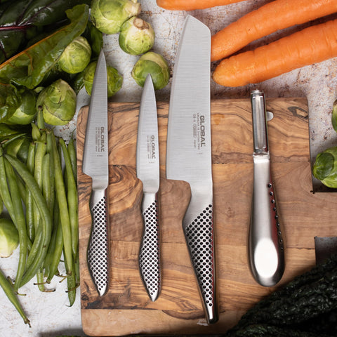 Global paring knife on cutting board removing pepper cores