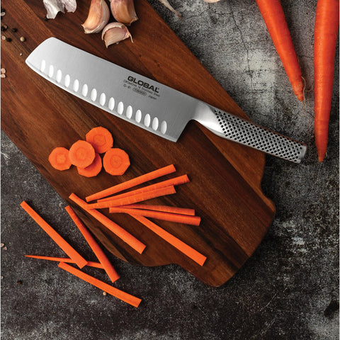 Global 7-inch vegetable knife shown on a cutting board for prep