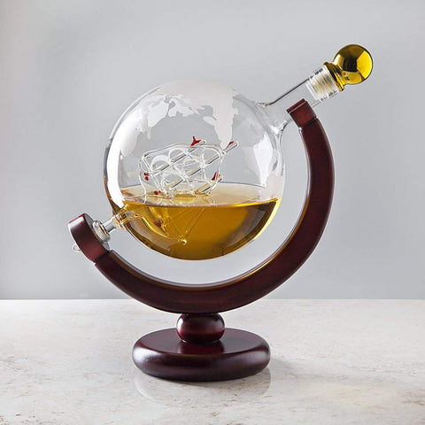 Godinger globe decanter sits on a mahogany stand for elegant presentation