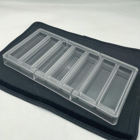 Goldbaking mold positioned in fridge to chill and set chocolates evenly
