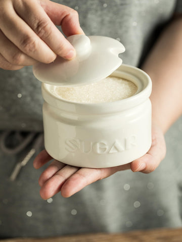Gomakren sugar jar with lid keeps contents dust-free on the counter.