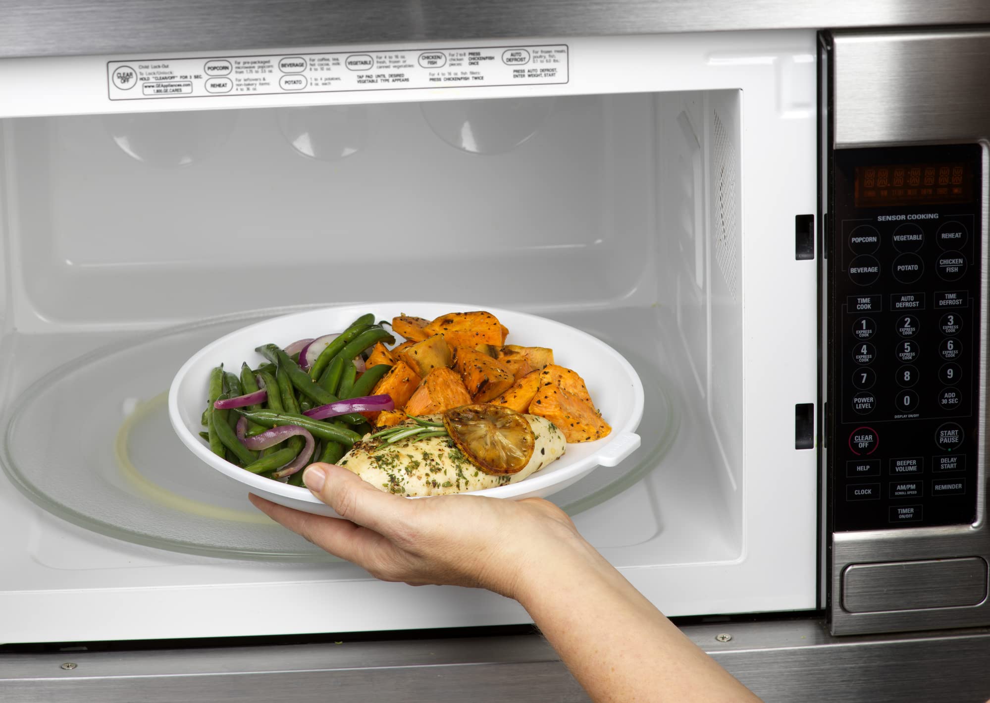 GoodCook cool-touch microwave plate demonstrates safe handling during use.