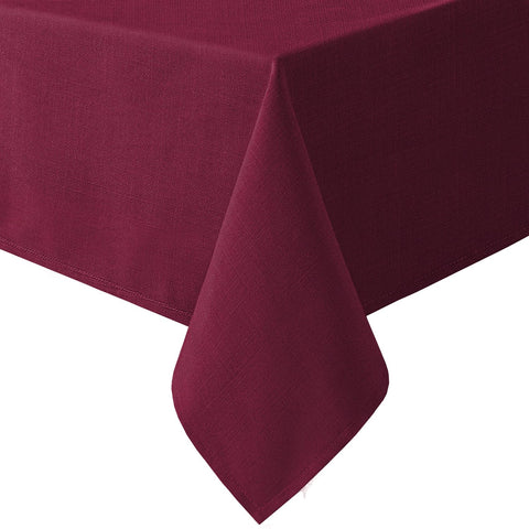 H.VERSAILTEX linen-textured tablecloth on a dining setup, offering durable protection and elegant fabric.