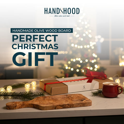 HandsHood olive wood cutting board grain closeup showing natural color and knife-friendly surface.