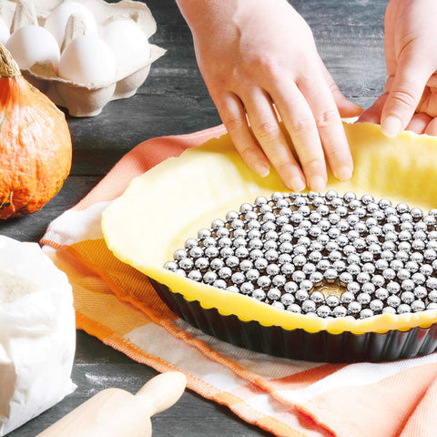 HANNAH'S BAKING stainless steel pie weights ready to shield crusts from bubbles