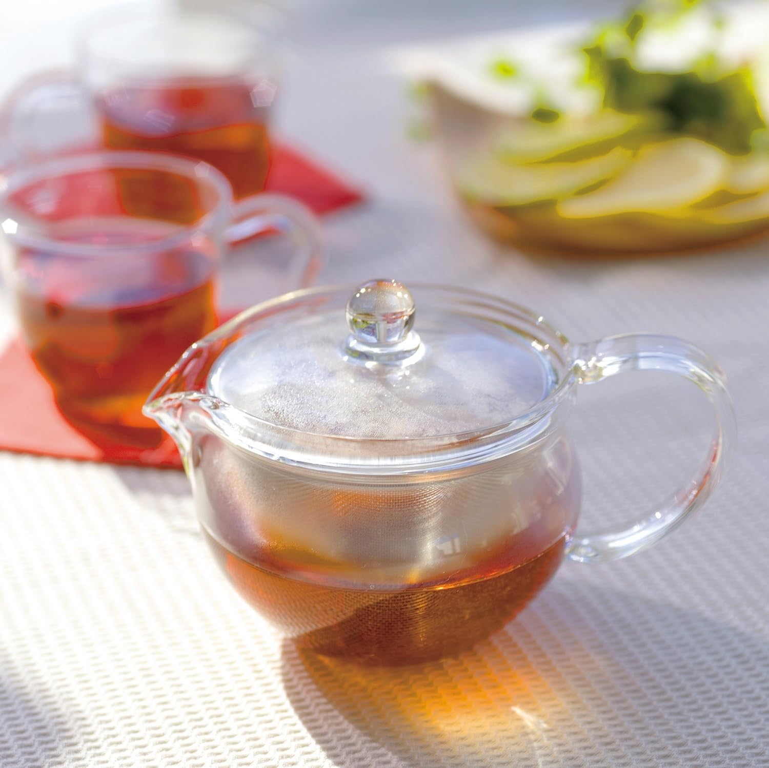 Elegant glass teapot showcases tea color, enhancing the sensory experience of brewing
