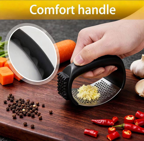 HavenNest garlic press demonstrating rocking action for easy crushing.