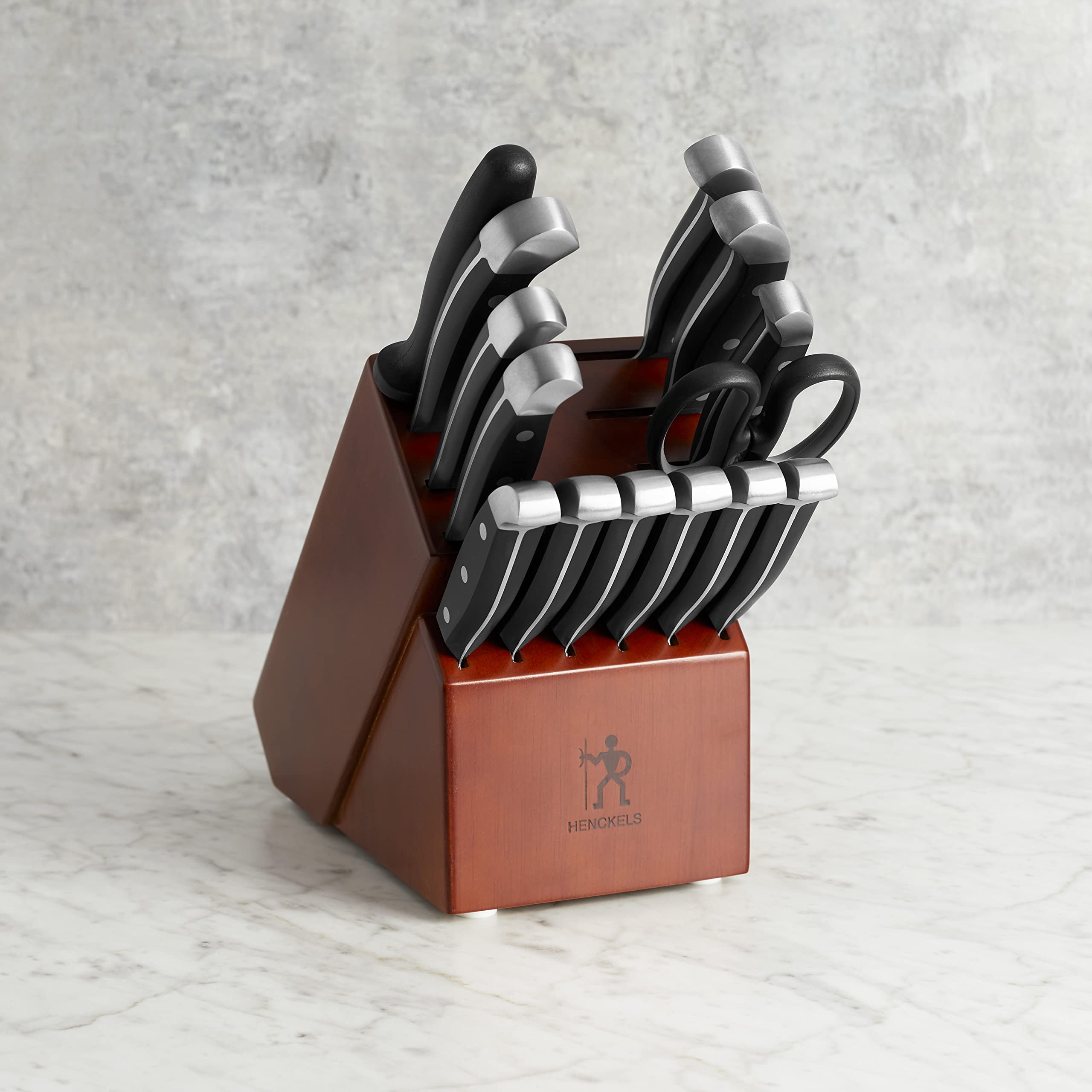HENCKELS 5-inch serrated utility knife designed for clean slicing through bread and produce.