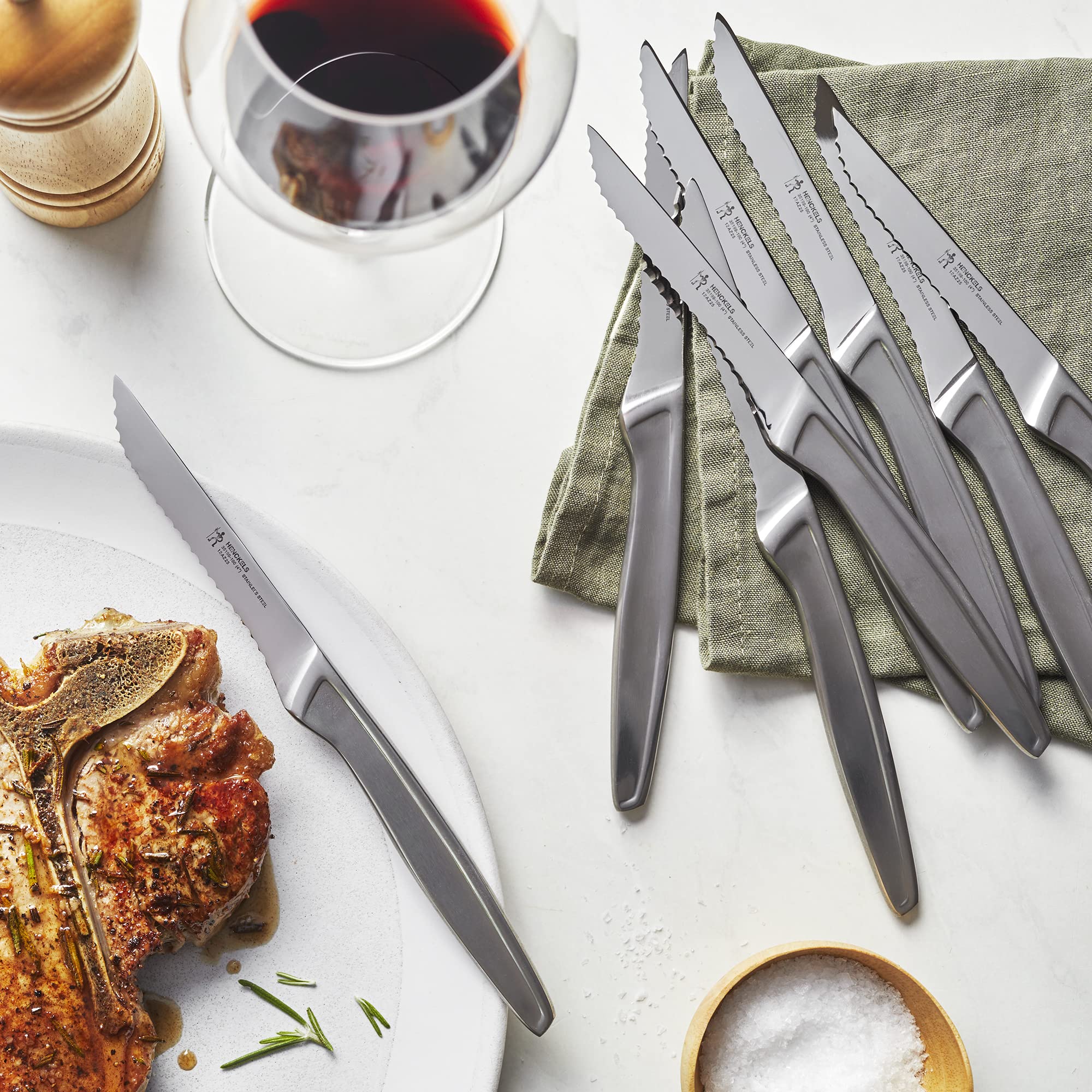 Henckels 8-piece steak knife set on table for effortless dining prep