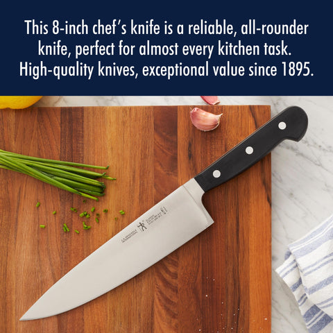 Henckels 8-inch chef knife dicing onions with uniform pieces.