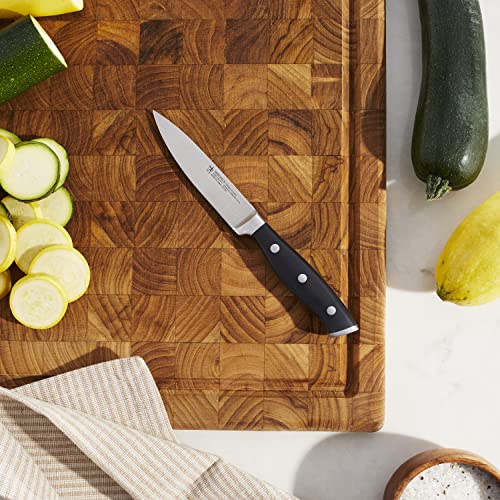 HENCKELS Forged Accent paring knife handle with curved triple rivets for balanced control.