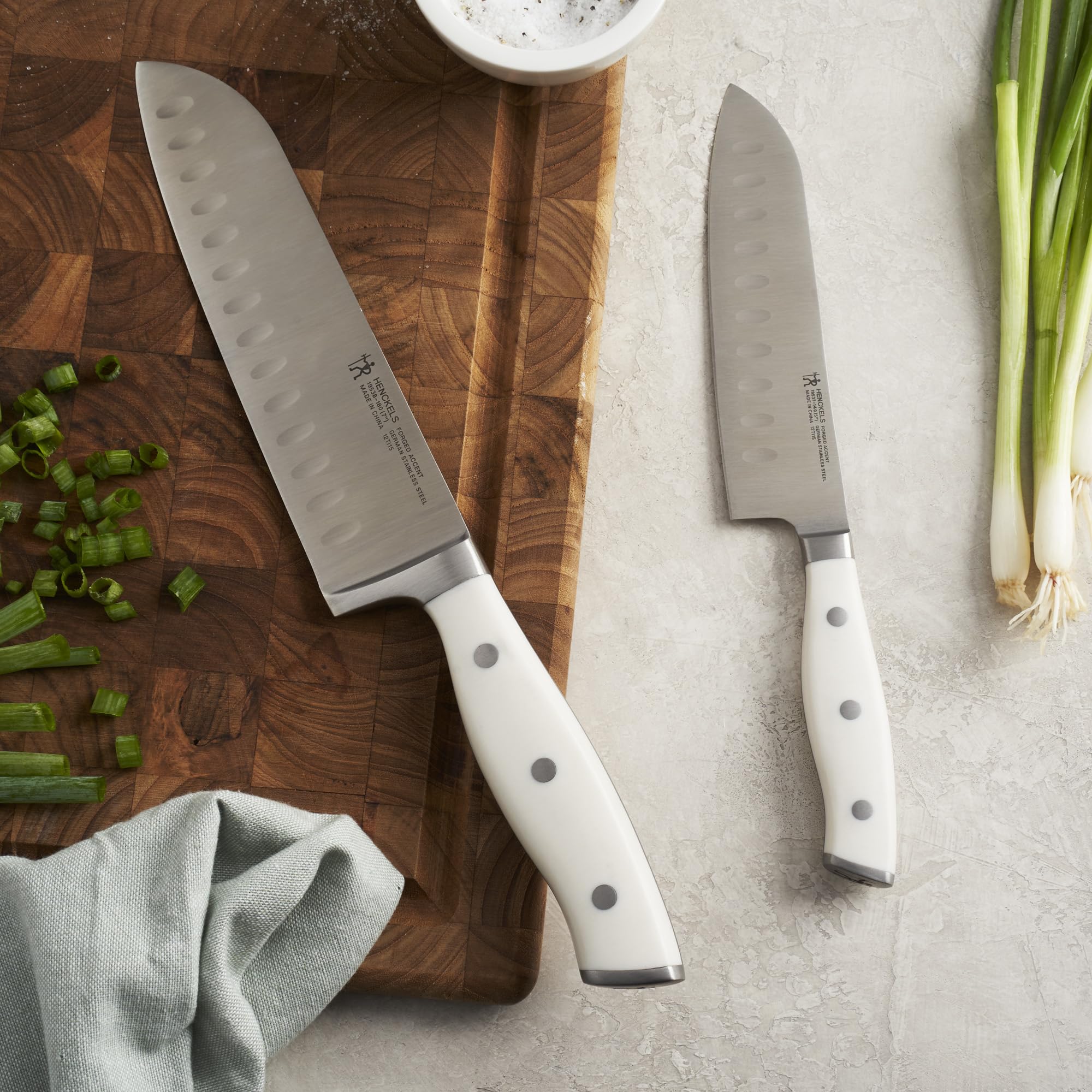 HENCKELS Forged Accent Santoku on cutting board for precise dicing and slicing
