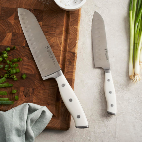 HENCKELS Forged Accent Santoku on cutting board for precise dicing and slicing