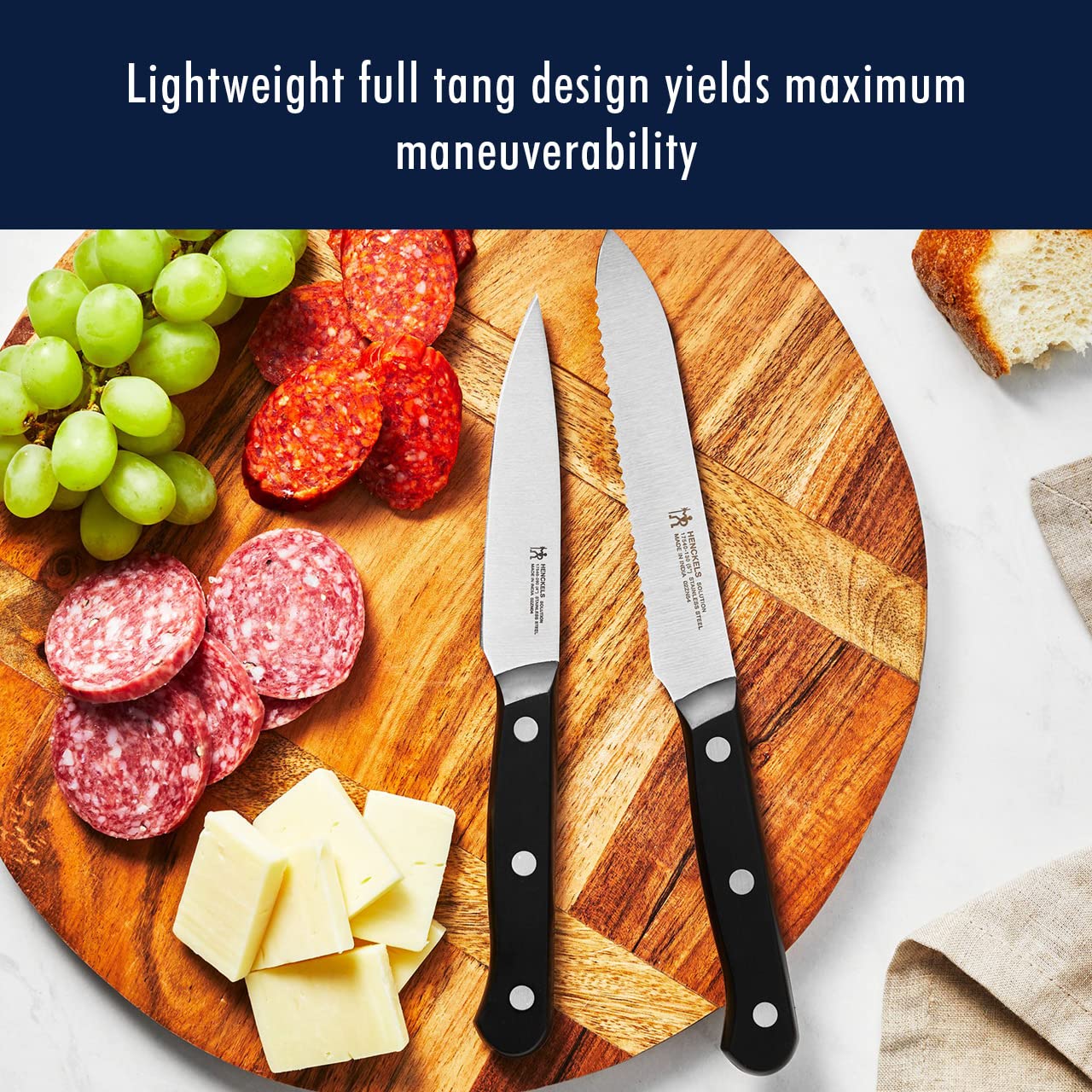 HENCKELS Solution 8x4.5-inch steak knives arranged in a row.