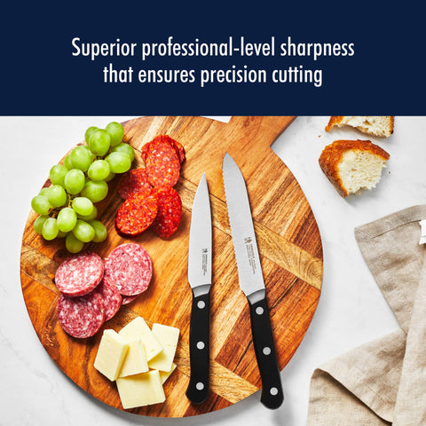 Henckels Solution Razor-Sharp 4-Inch Knife slicing fruits with ease.