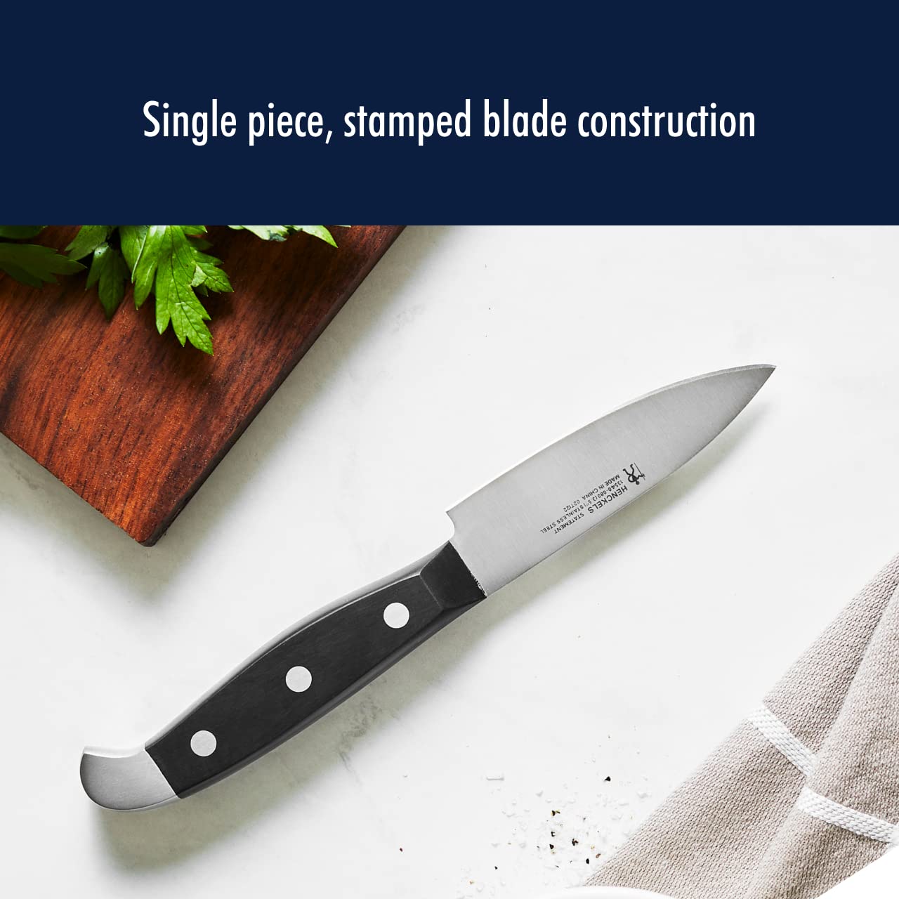 Henckels Statement 7-inch santoku with grantons for smooth, non-stick slicing.