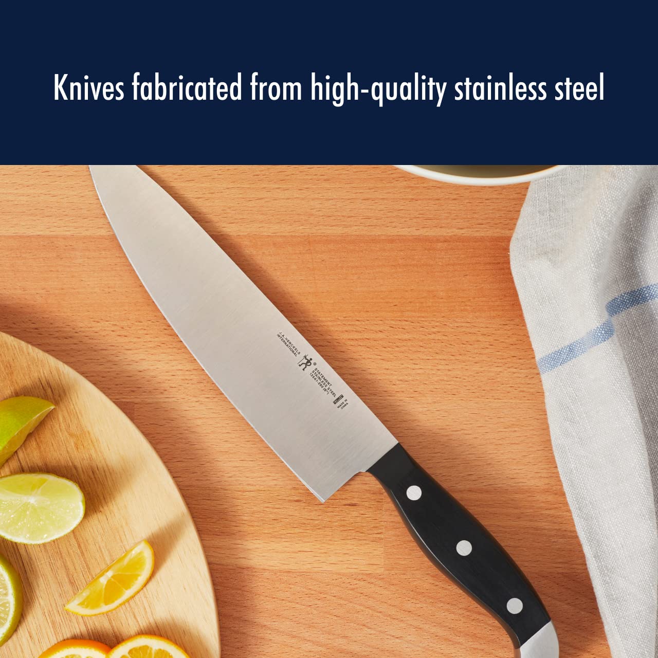 Henckels Statement 8-inch bread knife slicing through crusty loaf.