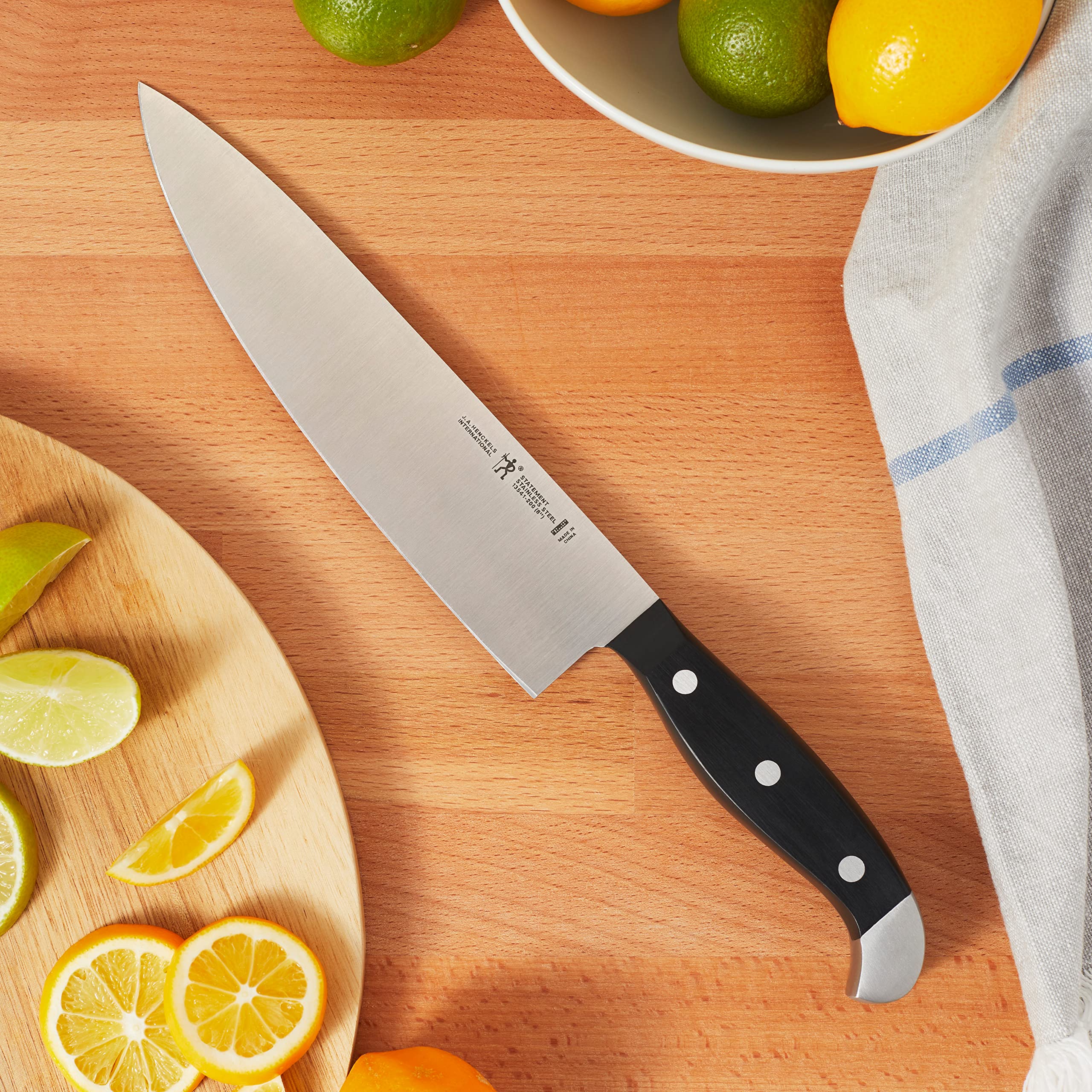 Henckels Statement 8-inch chef knife ready for chopping herbs and onions.