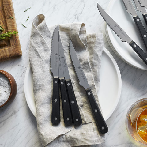 Henckels triple riveted handle close-up highlights durable balance.