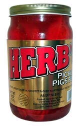 Herbs pickled pigs feet in a 16 oz jar, tangy snack ideal for charcuterie.