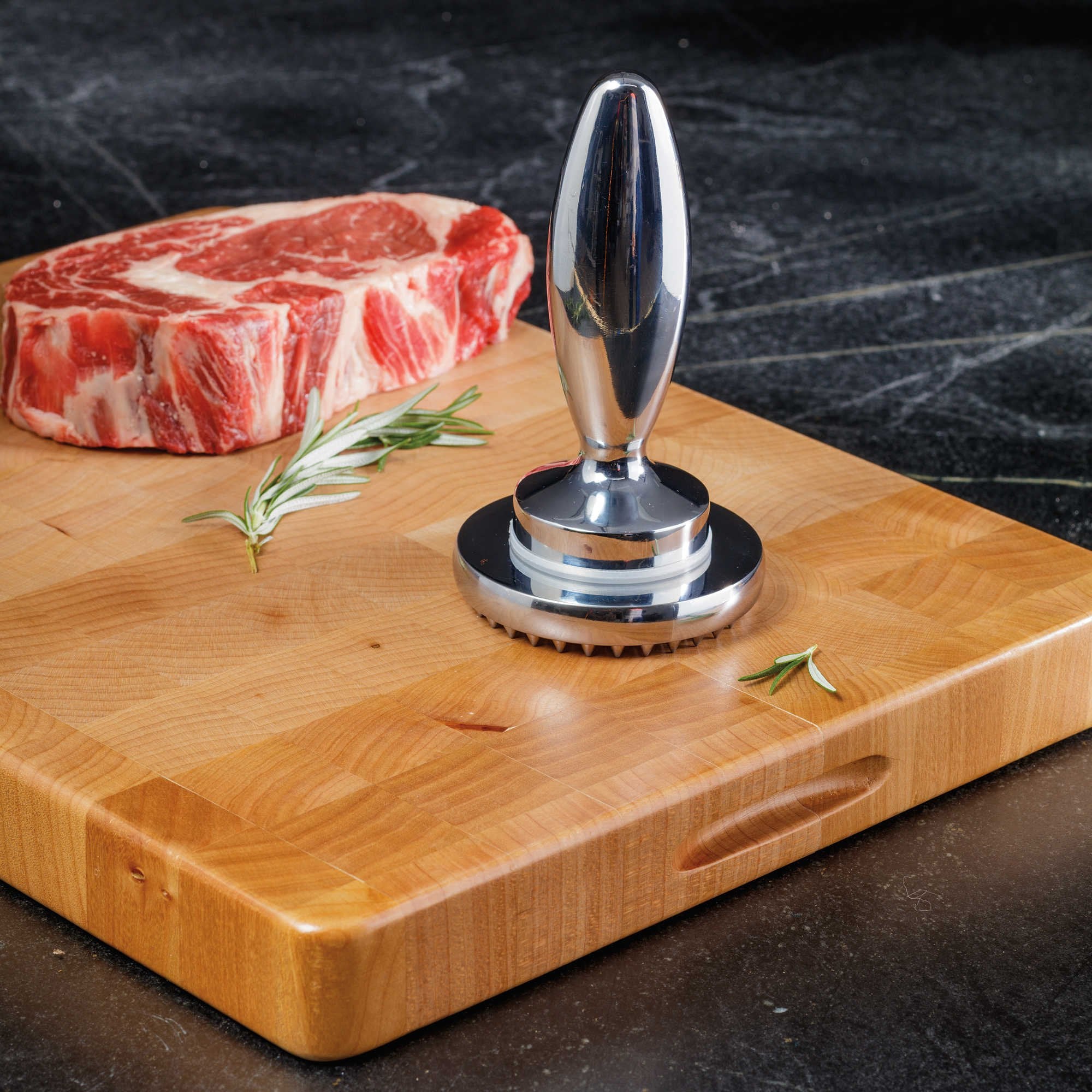 Hicook toothed side in action tenderizing beef or pork evenly.