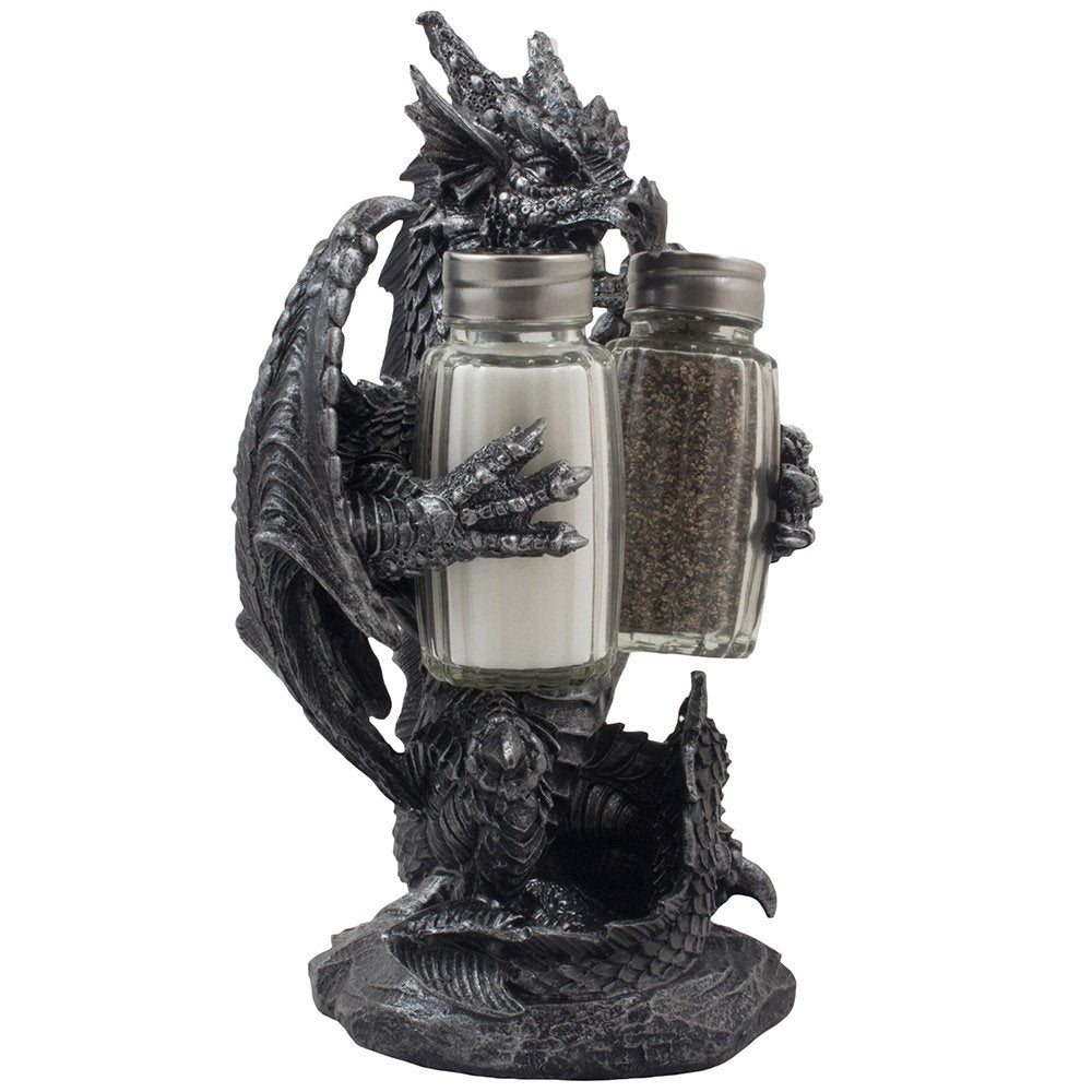 Close-up of granite-gray dragon sculpture guarding crystal salt and pepper shakers.