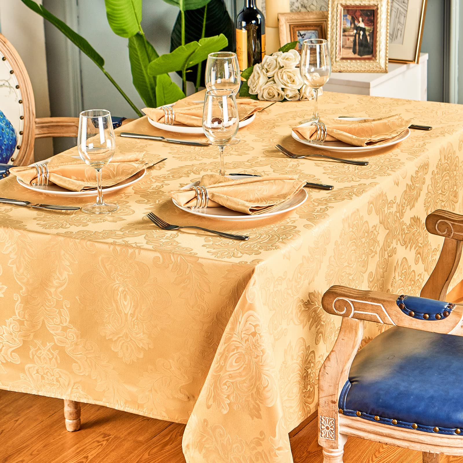 HomeJoy gold tablecloth in a festive dining setup with warm lighting.