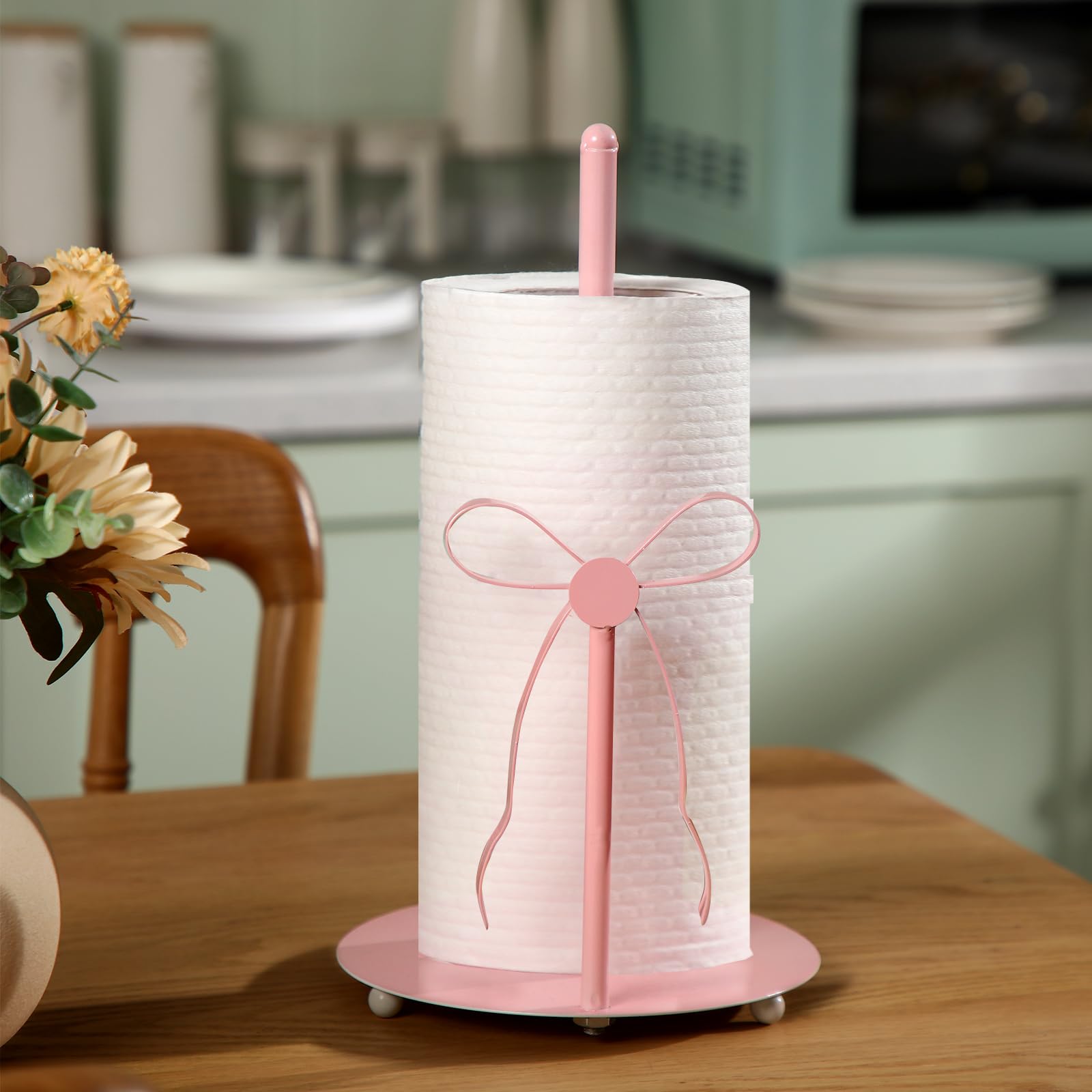 Honeydak pink bow paper towel holder on kitchen counter keeps towels within reach.
