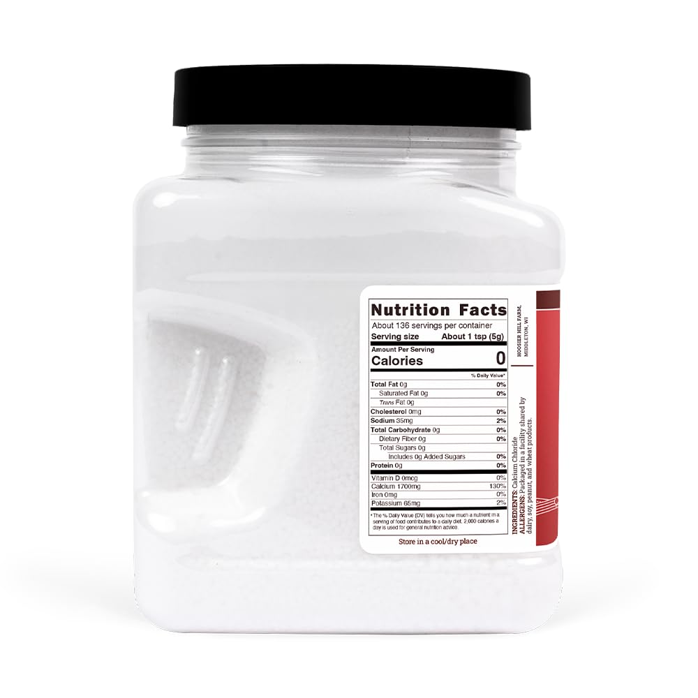 Hoosier Hill Farm Pickle Fresh Granules jar in hand showcases ready to use canning aid.