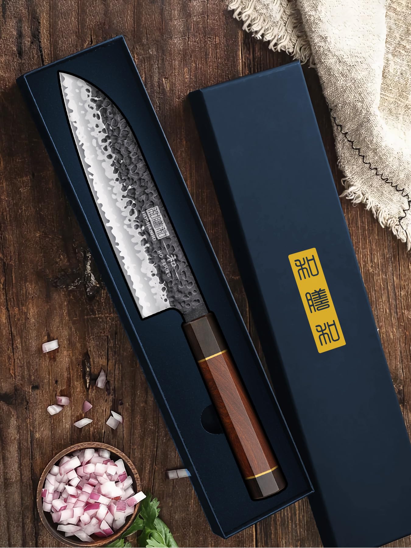HOSHANHO Santoku knife blade and handle in a professional kitchen setting.