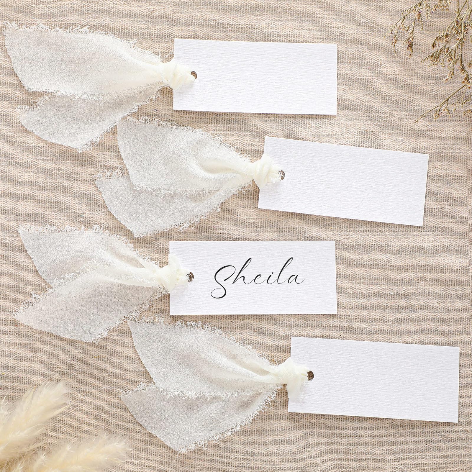 Humyoun ivory textured name cards ready for elegant wedding seating.