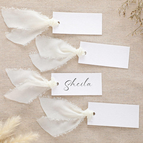 Humyoun ivory textured name cards ready for elegant wedding seating.