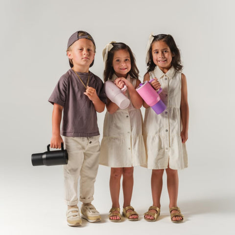 HydroJug Kids 20oz cream bottle inside a backpack ready for school.