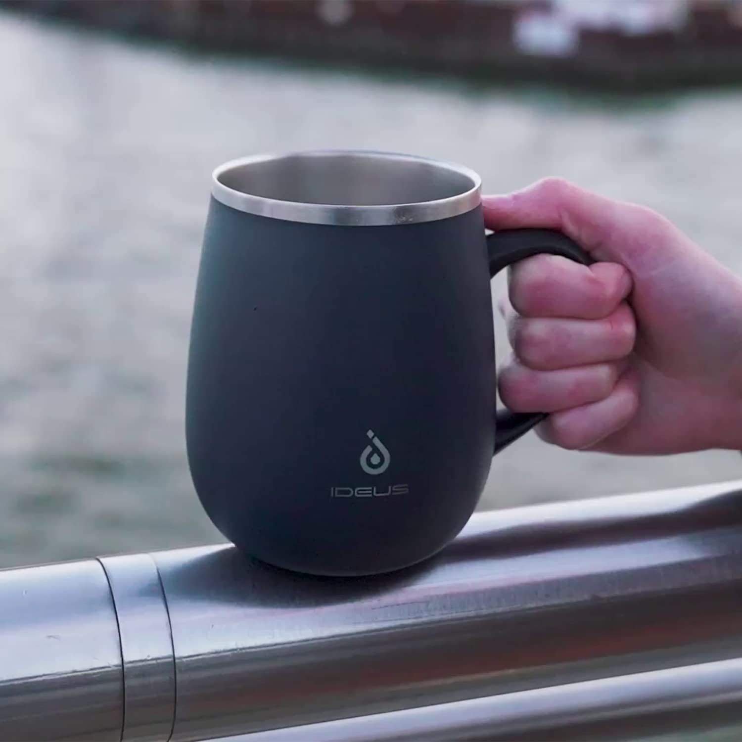 Ideus mug in use during a morning commute, showcasing portability.