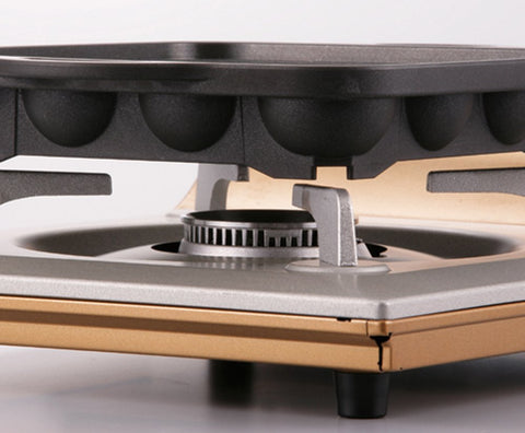 Iwatani Takoyaki Grill Pan hole detail shows non-stick surface for easy turning.