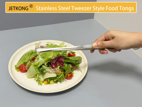 JetKong stainless steel tweezers in use on a barbecue grill