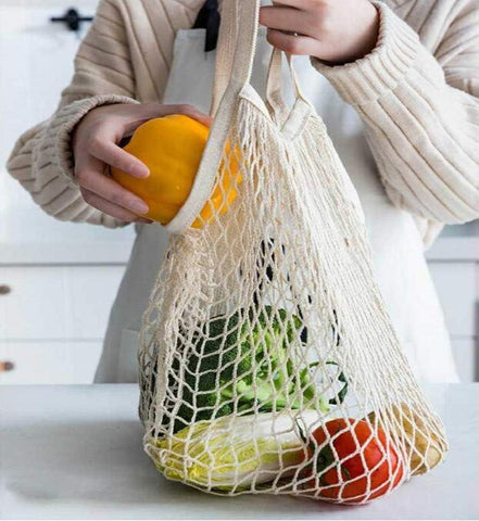 JM-capricorns beige mesh bag opened for fruits and veggies.