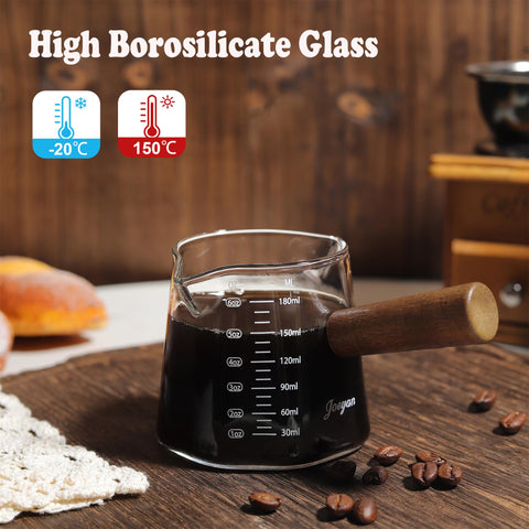 Joeyan measuring cup with wooden handle provides a comfortable grip for hot liquids.