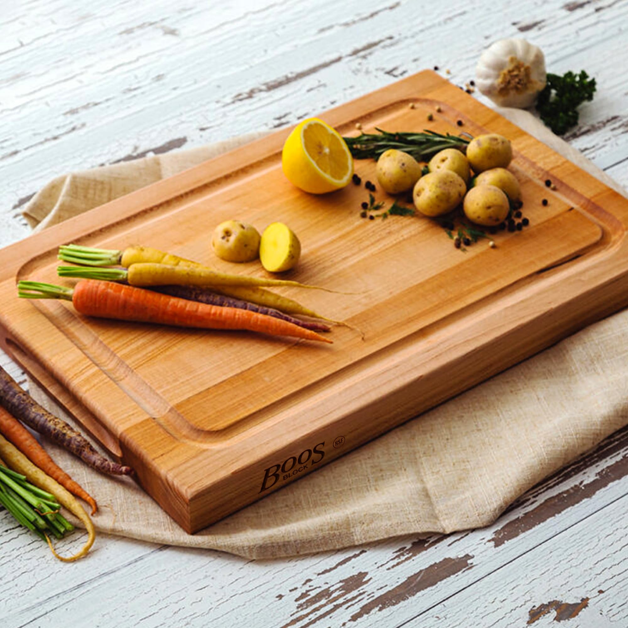 Kitchen prep area featuring John Boos BBQ Series cutting board