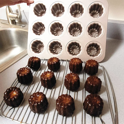 JRVT Love 12-cavity canele pan during baking action shows even heat distribution.