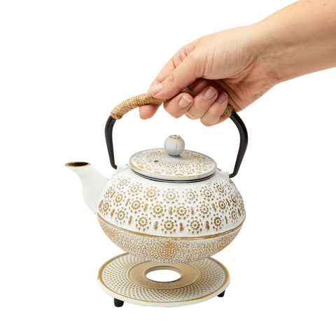 Juvale tea kettle with built-in infuser and trivet on display