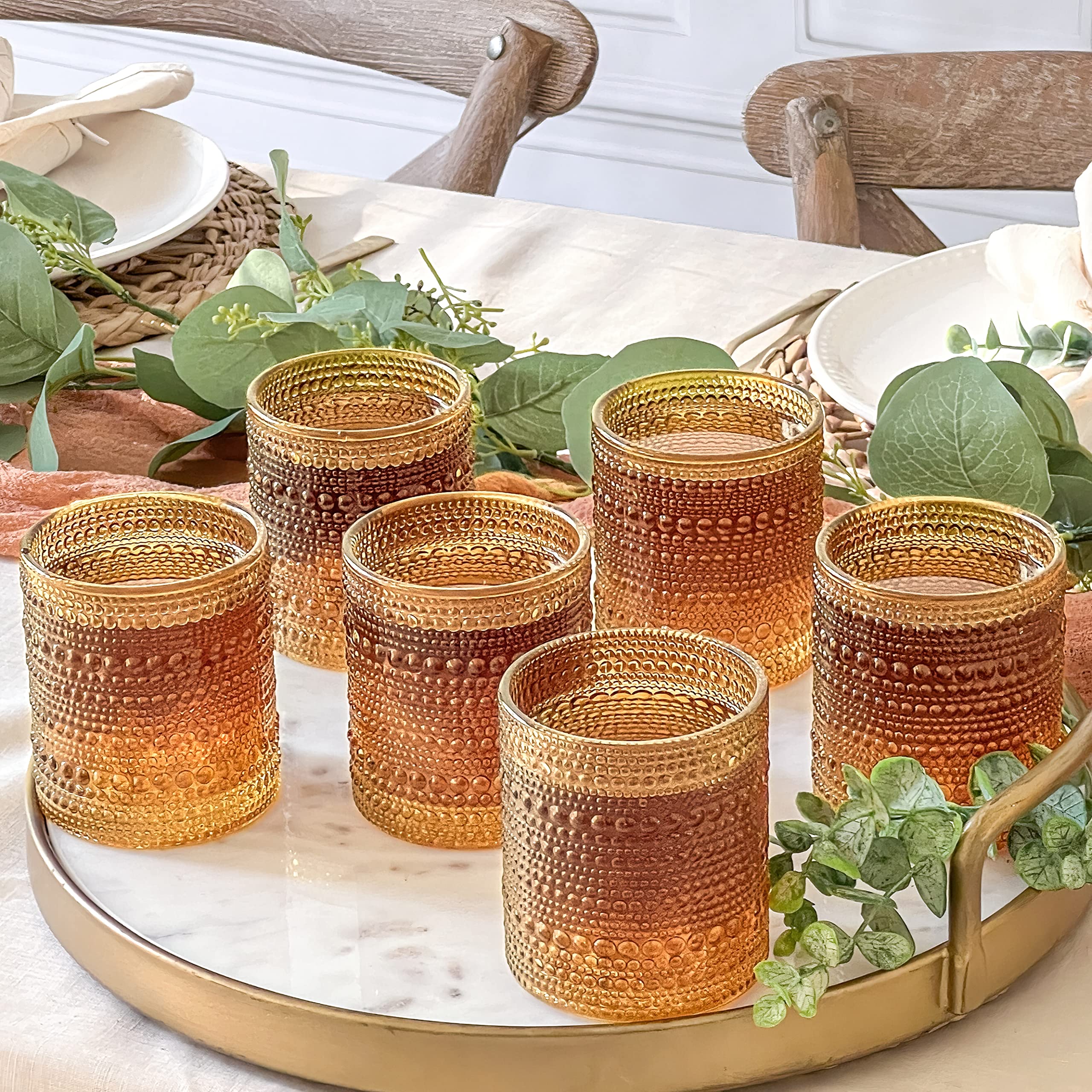 Kate Aspen amber glass on a bar cart adds vintage charm.