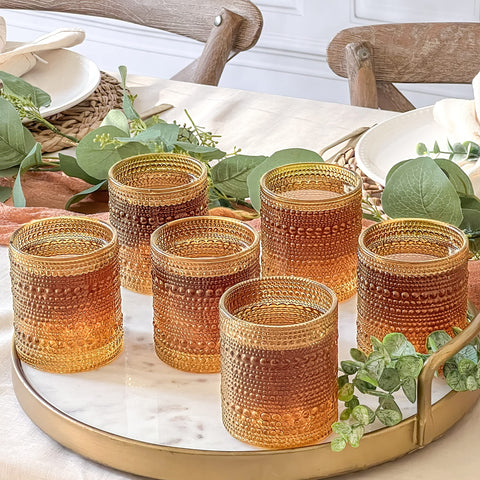 Kate Aspen amber glass on a bar cart adds vintage charm.