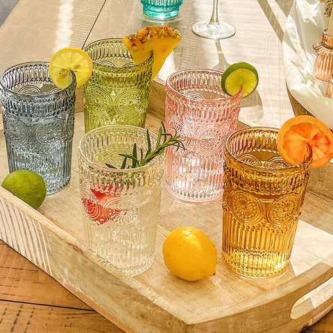 Kate Aspen green glassware displayed on a stylish bar cart.
