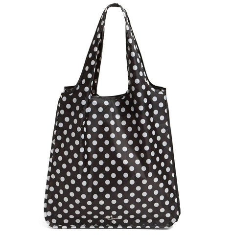Close-up of Kate Spade New York tote showing tie closure for secure packing.