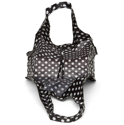 Lifestyle shot of Kate Spade New York tote styled with everyday items.