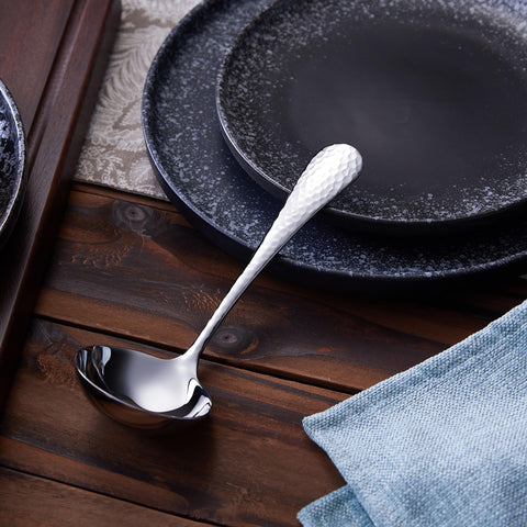 KEAWELL gravy ladle resting on table enhances dining presentation.