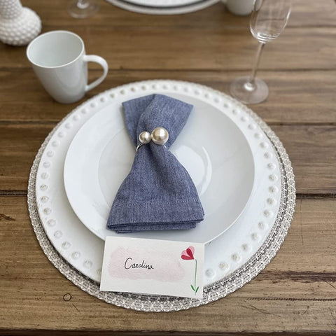 Kesote silver napkin rings arranged on dining table for refined decor.