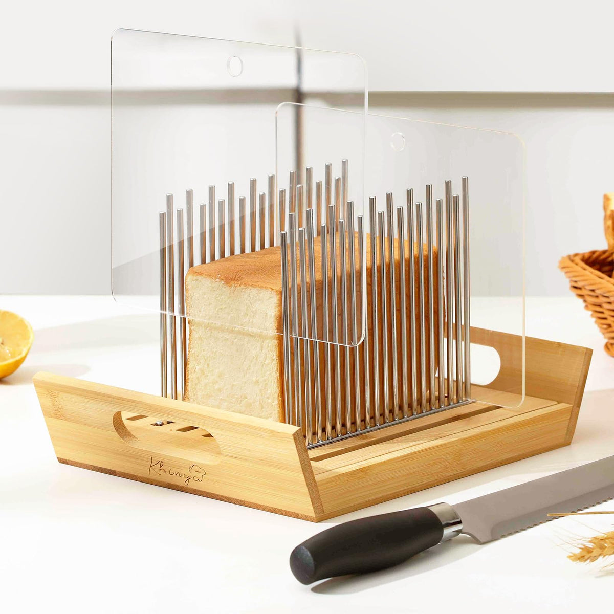 KHINYA bread slicer with boat-shaped tray catching crumbs and serving slices.