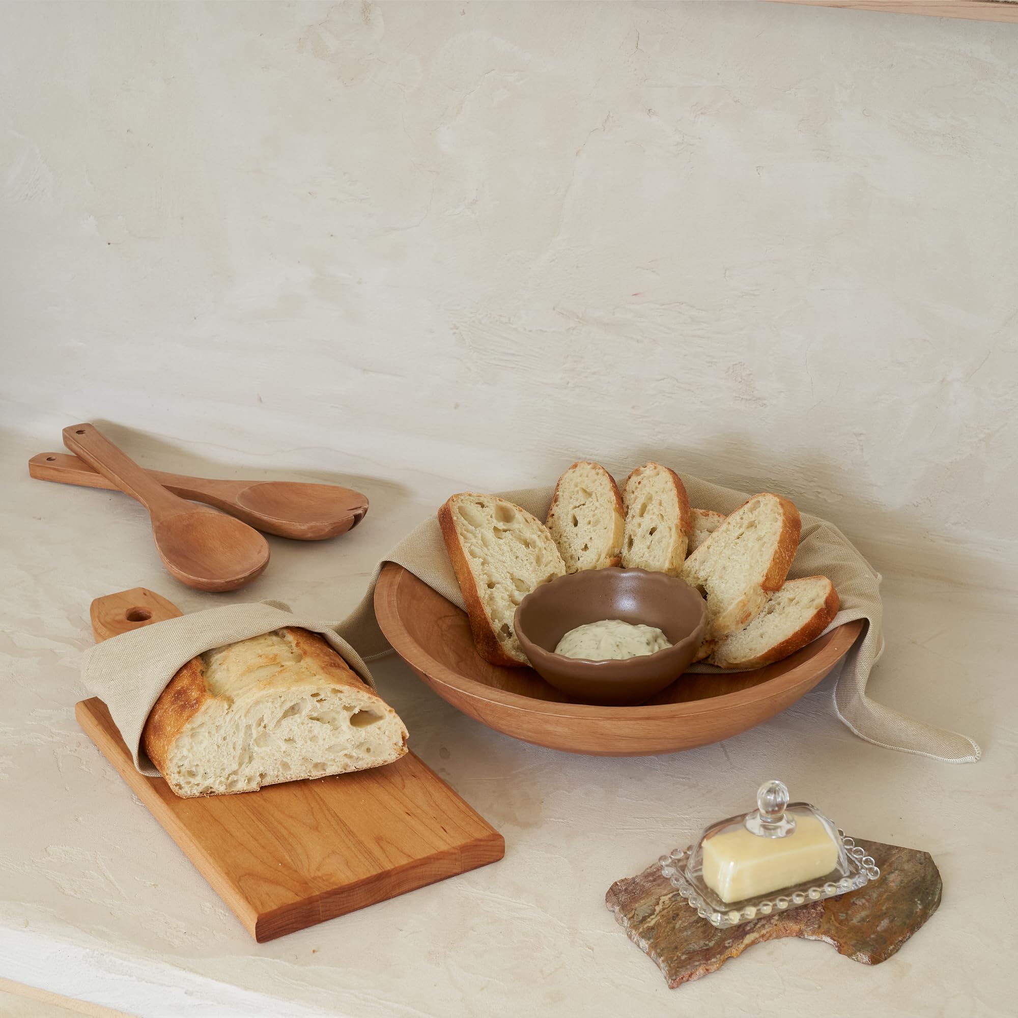 KIBAGA dining table setup with bowl and fruits conveys stylish entertaining.